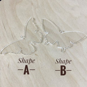 May include: Two clear acrylic butterfly shapes, one labelled "Shape -A-" and the other labelled "Shape -B-".