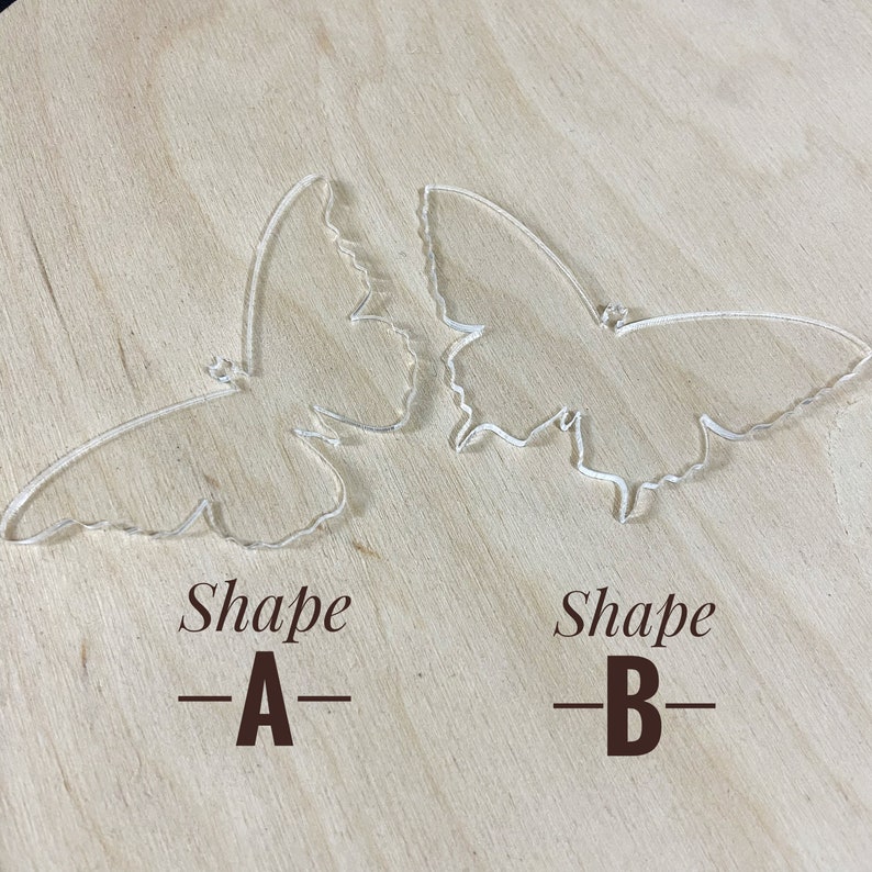 May include: Two clear acrylic butterfly shapes, one labelled "Shape -A-" and the other labelled "Shape -B-".