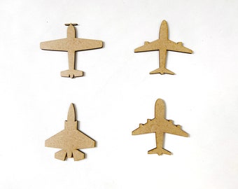 May include: Four wooden airplane cutouts in different styles. The airplanes are all brown and are arranged in a row on a white background.