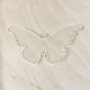 May include: A clear acrylic butterfly cutout, ideal for crafting or home decor.