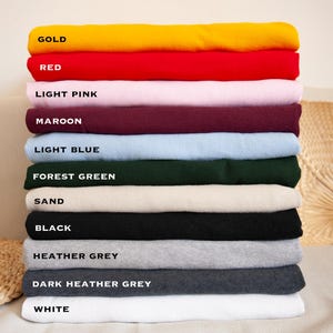 a stack of folded towels sitting on top of a bed