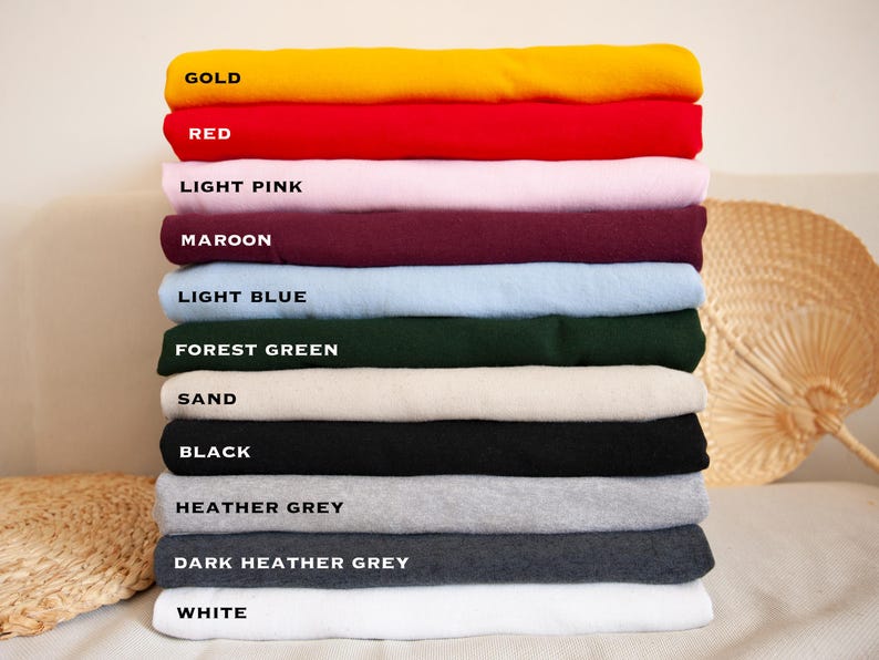 a stack of folded towels sitting on top of a bed