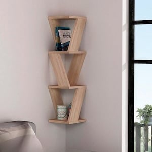 May include: A light wood corner shelf unit with three shelves. The shelves are shaped like a V and are stacked on top of each other. A book titled "Moby Dick" is on the top shelf. A small decorative container is on the bottom shelf.