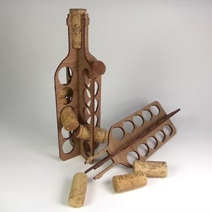 May include: Wooden wine bottle cork holder with a bottle shaped design and slots for storing corks. The holder is made of light brown wood and has a natural finish. There are several corks scattered around the holder.