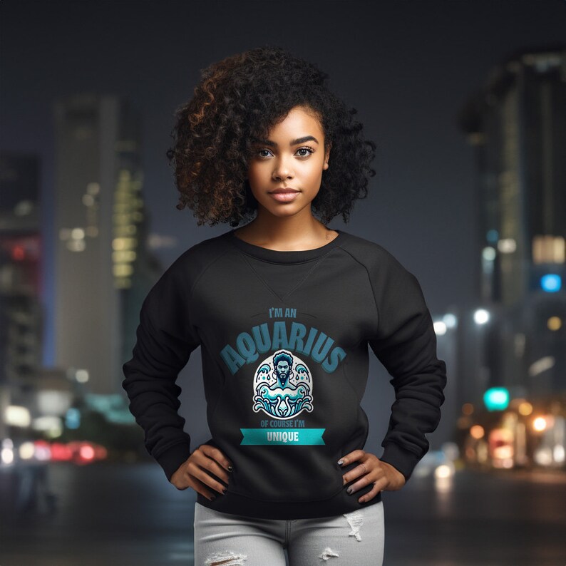 May include: Black sweatshirt with a blue and white graphic that says "I'm an Aquarius, of course I'm unique".