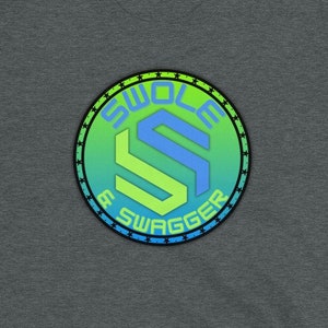 May include: A dark heather grey t-shirt with a green, blue, and black logo that says "Swole & Swagger" in a circular design.
