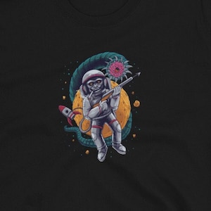 May include: Black t-shirt with a graphic of an astronaut in space holding a gun and fighting a space monster.