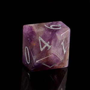 May include: A purple amethyst gemstone d6 dice with silver numbers 1, 2, 3, 4, 5, and 6.