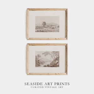 May include: Two framed vintage landscape prints in a light wood frame. The prints are in black and white and depict a lake scene with trees and mountains.