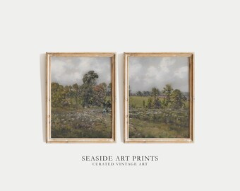 May include: Two framed landscape paintings in a rustic style. The paintings depict a rural scene with trees, fields, and a cloudy sky. The frames are a light wood colour.