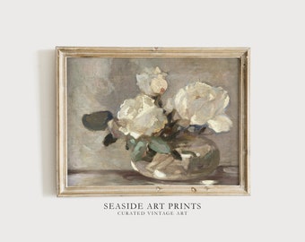 May include: A vintage painting of white roses in a clear glass vase. The painting is framed in a light wood frame and has a soft, muted color palette.