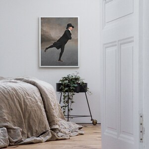 May include: A framed black and white illustration of a man ice skating in a black coat and top hat. The illustration is set against a light gray background with a faint mountain range in the distance.