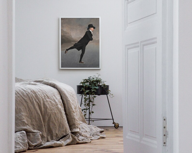 May include: A framed black and white illustration of a man ice skating in a black coat and top hat. The illustration is set against a light gray background with a faint mountain range in the distance.