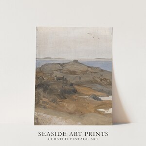 May include: A vintage painting of a rocky island with a small house in the distance. The sky is a light blue and the water is a dark blue. The rocks are a light brown and the house is a dark brown. The painting is in a muted color palette with a soft, dreamy feel. The painting is titled 'Seashore' and is part of a collection of curated vintage art prints.