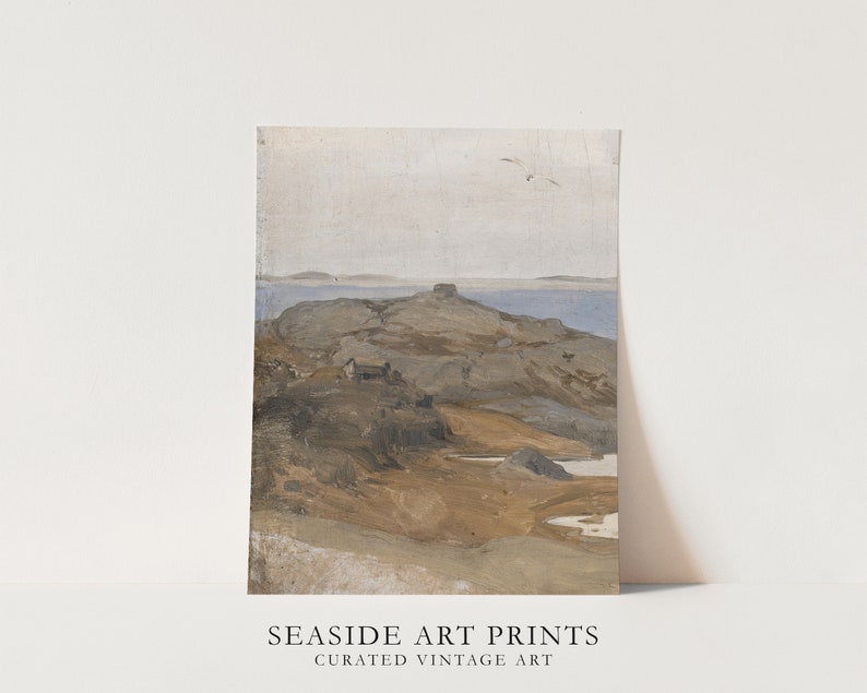 May include: A vintage painting of a rocky island with a small house in the distance. The sky is a light blue and the water is a dark blue. The rocks are a light brown and the house is a dark brown. The painting is in a muted color palette with a soft, dreamy feel. The painting is titled 'Seashore' and is part of a collection of curated vintage art prints.