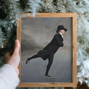 May include: A framed painting of a man in a black coat and top hat ice skating on a frozen lake. The painting is set against a gray and white background.