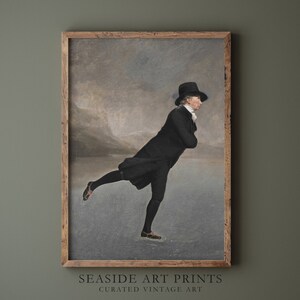 May include: A vintage painting of a man ice skating in a black coat and hat on a frozen lake. The painting is set against a cloudy sky and a distant mountain range.