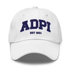 May include: A white baseball cap featuring the dark blue embroidered text ADPI in a large arched font, with the smaller text EST 1851 centered directly underneath. The cap has a structured crown, a curved brim, and a button at the top center.