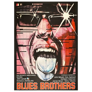 Puede incluir: Un póster de película vintage para la película "Blues Brothers" con un primer plano de la cara de John Belushi con la lengua fuera. El póster es rojo, negro y azul con un efecto de estrella blanca.