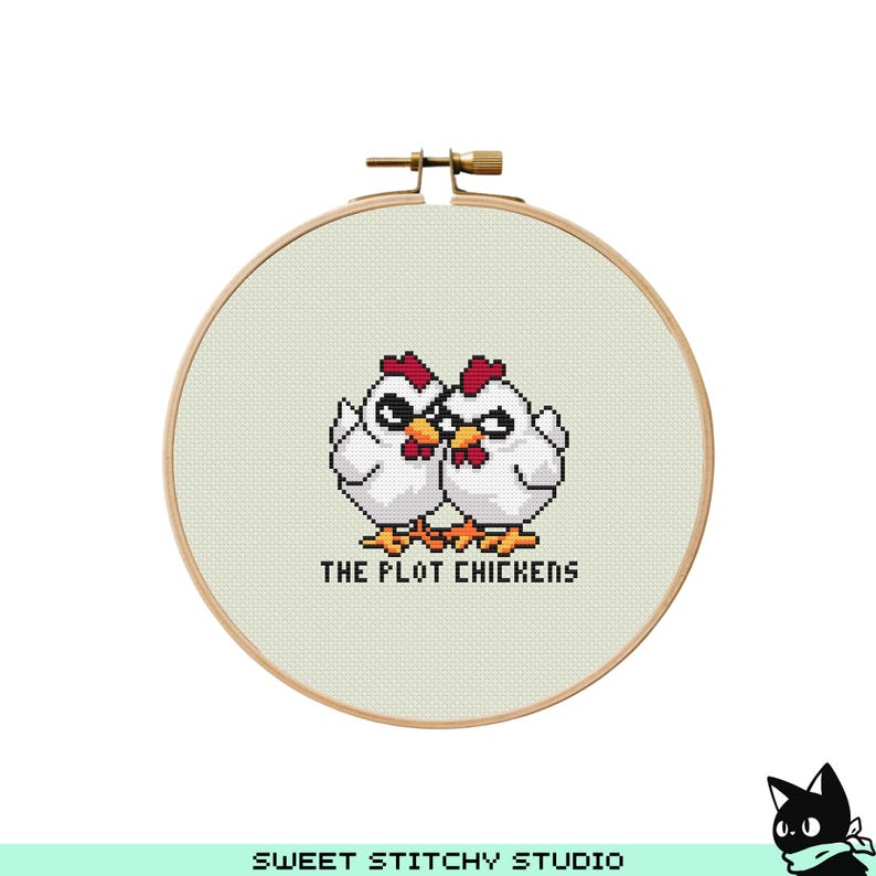 May include: A white embroidery hoop with a cross-stitch design of two chickens with red combs and the text "The Plot Chickens".