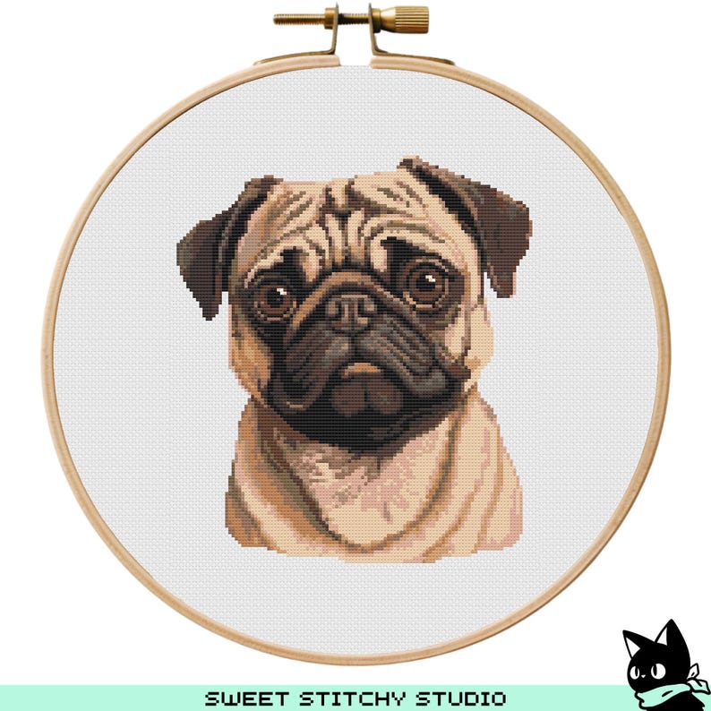 May include: Cross stitch pattern of a pug dog with brown eyes and a wrinkled face. The pattern is on a white background and is framed in a wooden hoop.