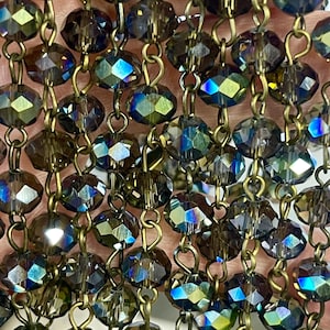 7.4mm x 5mm, Grey with Green Reflection Transparent, Faceted Glass Bead Chain with Brass Color Wire. Bead Chain. Priced by the foot.