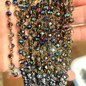 A1  6mm x 5mm, Blue with Purple Reflection, Faceted Glass Bead Chain, Transparent, Faceted Glass with Brass Color Wire. Priced by the foot.