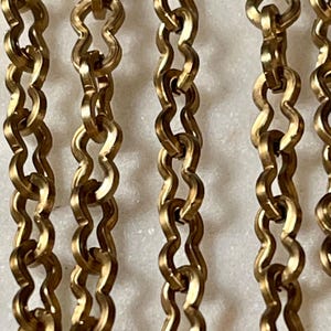 Raw Brass, No Plating, Peanut Shape Cable Chain. 4.11 x 7.27, Soft, Natural Brass Color.  Excellent Quality.  Priced by the foot