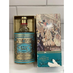 May include: A glass bottle of 4711 Kolnisch Wasser Original Eau de Cologne with a gold cap and a blue and gold label featuring the number 4711. Beside it stands a rectangular cardboard box with a vintage illustration of a horse and people.