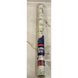 May include: Rolled drawer and shelf liner with a floral pattern in pastel colors. The label reads "drawer & shelf liner" and "20 IN". The liner is on a white background with a gold and brown pattern.