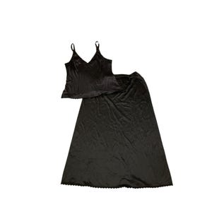 May include: Black satin lingerie set featuring a camisole top with adjustable straps and a V-neckline, paired with a matching long skirt. The edges of the top and skirt are trimmed with delicate lace.