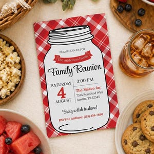 May include: A family reunion invitation with a red and white gingham background. The invitation features a mason jar graphic and text that reads "Family Reunion" and event details. Food and drinks surround the invitation.