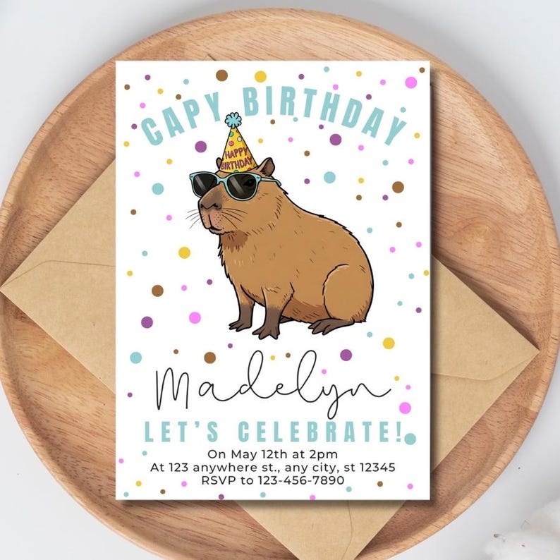 May include: Birthday invitation featuring a cartoon capybara wearing sunglasses and a party hat. The invitation reads "CAPY BIRTHDAY Madelyn LET'S CELEBRATE!" with event details and RSVP information. The design includes colorful confetti.