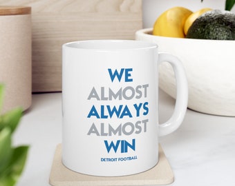 Detroit Lions | We Almost Always Almost Win | Football Mug | White Glossy Mug | Perfect Gift Idea | Funny NFL Gift | Sport Themed Mug