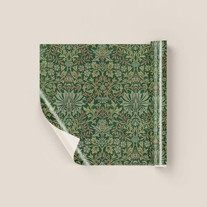 a square-shaped pattern with a repeating floral design in shades of green and brown.