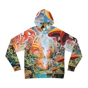 Puede incluir: Una sudadera con capucha colorida con un estampado psicodélico de bosque de setas. El estampado presenta una variedad de setas en tonos naranja, amarillo, rosa y azul, con un arroyo azul que atraviesa el centro.