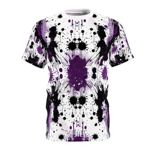 May include: A white t-shirt with a purple and black paint splatter design. The design is symmetrical and features a large purple splatter in the center.