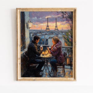 May include: Oil painting of a couple enjoying drinks on a balcony overlooking Paris at sunset. The Eiffel Tower is visible in the background. The painting is framed in a gold-colored wooden frame.