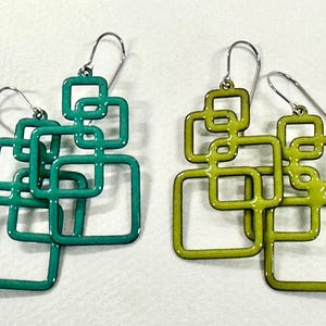 May include: Two pairs of dangle earrings featuring interconnected square frames. One pair is a vibrant teal color, and the other pair is a bright lime green. Each earring is suspended from a simple silver-toned metal hook wire for attachment.