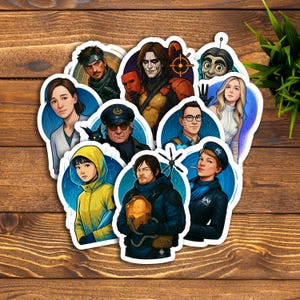 May include: A selection of colourful die-cut stickers, each depicting character illustrations. The stickers showcase a variety of individuals with unique designs and vibrant colours. The stickers are arranged on a wooden surface.