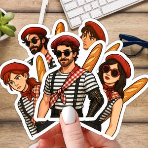 May include: A selection of stickers showcasing cartoon illustrations of individuals in French-inspired outfits. Each sticker presents a person wearing a red beret, a striped top, and holding a baguette. Some characters are wearing sunglasses and red scarves.