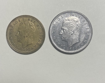 Una-peseta uit 1975 en vijf peseta's uit 1989 - Spaanse munten