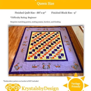 May include: A Queen-size quilt with a checkerboard pattern in orange, yellow, and navy blue. The quilt has a lavender border with floral embroidery and a dark purple binding. The finished size is 88" x 97".