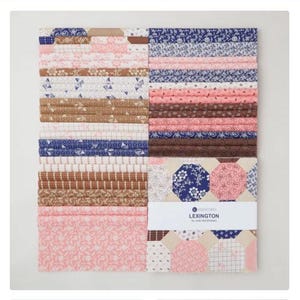 May include: A collection of fabric squares in various patterns and colors, including pink, blue, brown, and white. The fabrics are arranged in neat stacks, with some featuring floral and geometric designs. A label reads "Lexington by Jan Patek Home".