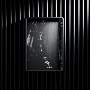 May include: Black and white photograph of a race car driving through a tunnel. The car is in motion and the tunnel is dark and narrow.