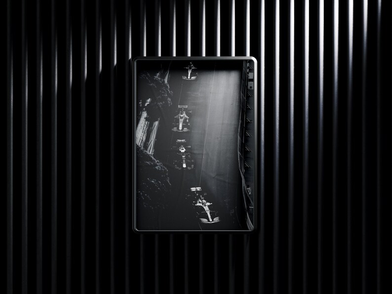 May include: Black and white photograph of a race car driving through a tunnel. The car is in motion and the tunnel is dark and narrow.