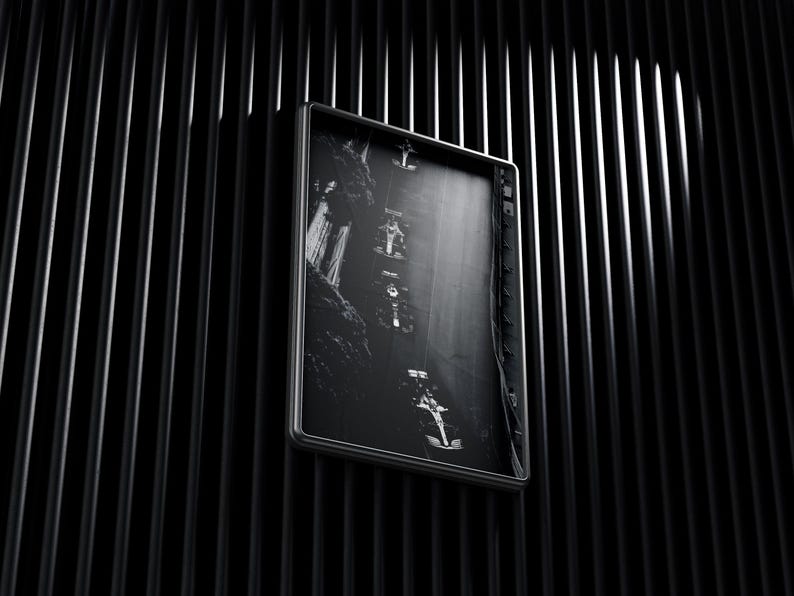 May include: Black and white photograph of a waterfall in a forest, framed in a black frame.