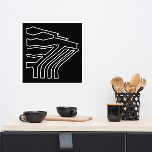 May include: Black and white abstract line art print of a building with a geometric design. The print is framed and hanging on a white wall.