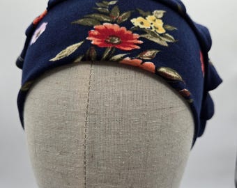 Floral Scrub Hat: Soft Stretch Knit, Elastic Back. Blue with red and yellow flowers.