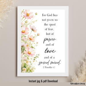 May include: A framed print featuring a watercolor floral design with pink and yellow flowers. The text reads "For God has not given us the spirit of fear, but of power and of love and of a sound mind. 2 Timothy 1:7." The words "Instant jpg & pdf Download" are also visible.